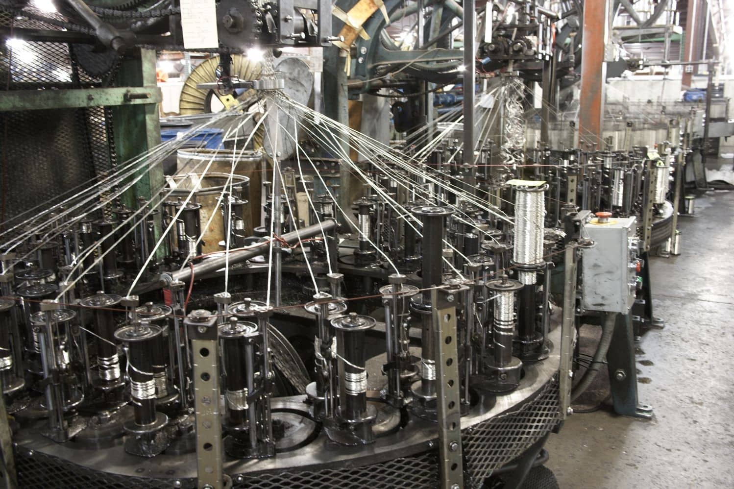 Finished copper wire coils stored in a factory setting.